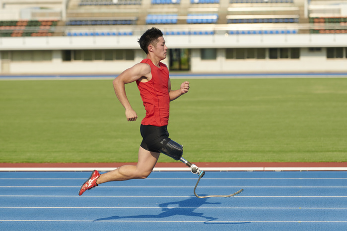 Track and field athlete with running prosthetic leg