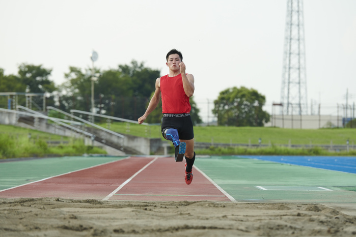 Long jumper with prosthetic leg running aids