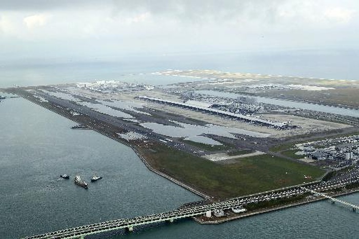 Typhoon No. 21 Aerial view at Kansai Airport, runway still flooded overnight after Typhoon No. 21. Early in the morning of May 5, activities began to rescue by boat and bus approximately 3,000 travelers who had been isolated on the Kansai Airport island due to Typhoon No. 21, which swept through Shikoku and the Kinki region on May 4. At Kansai Airport, almost all of Runway A  3,500 meters long  and the tarmac on the first phase island were flooded with up to approximately 50 centimeters of water due to seawater flowing in from the high tides. Machinery rooms and other facilities in the basement of the Terminal 1 building were also flooded, resulting in power outages in some areas.  The runway remains flooded overnight after Typhoon No. 21. In the left foreground is a tanker that collided with the connecting bridge  7:51 a.m., September 5, at Kansai International Airport, from the head office helicopter . Photo taken on September 5, 2018.  Kansai Airport Reopening Unlikely  appeared in the Osaka Evening News on September 6, 2018.