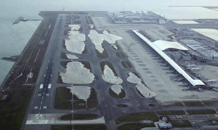 Typhoon No. 21 Aerial view of Kansai Airport with water remaining on the runway The Kansai International Airport was severely damaged by Typhoon No. 21. The runway was flooded and the connecting bridge was damaged, leaving many users of the airport isolated. The damage highlighted the difficulty of disaster prevention measures at  sea airports.  Water remains on the runway at Kansai International Airport  photo by Naoya Masuda, taken from the head office s helicopter on September 5 . Photo taken on September 5, 2018, published in the morning edition of the same month on September 6  scanner .