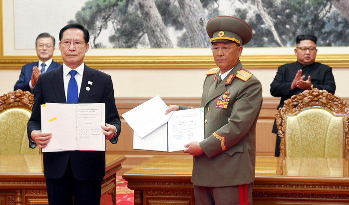 Inter Korean Summit in Pyongyang  Inter Korean Summit, Sep 19, 2018 : South Korean Defence Minister Song Young Moo  front L  and his North Korean counterpart No Kwang Chol hold the agreement about military issues that they signed as South Korean President Moon Jae In and North Korean leader Kim Jong Un look on at the Paekhwawon State Guest House in Pyongyang, North Korea. The two Koreas agreed on Wednesday to set maritime, air and ground buffer zones in front line areas as part of efforts to reduce military tensions, prevent accidental clashes and build trust, local media reported. EDITORIAL USE ONLY  Photo by Pyeongyang Press Corps Pool AFLO   NORTH KOREA 