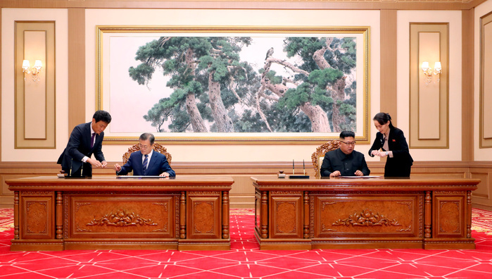 Inter Korean Summit in Pyongyang  Inter Korean Summit, Sep 19, 2018 : North Korean leader Kim Jong Un and South Korean President Moon Jae In attend a ceremony to sign on the summit agreement after their inter Korean summit at the Paekhwawon State Guest House in Pyongyang, North Korea. North Korean leader Kim agreed to permanently dismantle major missile engine test facilities and a launch pad near its border with China. The two Koreas agreed to intensify cross border exchange and work together for balanced economic development on the Korean Peninsula and agreed to break ground for a joint project to connect railways and roads across their borders within this year as part of efforts to beef up inter Korean cooperation, local media reported. EDITORIAL USE ONLY  Photo by Pyeongyang Press Corps Pool AFLO   NORTH KOREA 