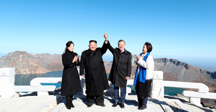Inter Korean Summit in Pyongyang  Inter Korean Summit, Sep 20, 2018 : North Korean leader Kim Jong Un  2nd L  and South Korean President Moon Jae In  2nd R  raise each other s hand atop Mount Paekdu, northeast of Pyongyang, North Korea as the South s first lady Kim Jung Sook  R  and the North s first lady Ri Sol Ju look on. North Korean leader Kim and South Korean President Moon visited Mount Paekdu, the highest peak of the Korean Peninsula which is considered the birthplace of the Korean people in a symbolic gesture showing their commitment to reconciliation, local media reported. EDITORIAL USE ONLY  Photo by Pyeongyang Press Corps Pool AFLO   NORTH KOREA 