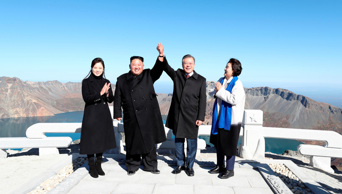 Inter Korean Summit in Pyongyang  Inter Korean Summit, Sep 20, 2018 : North Korean leader Kim Jong Un  2nd L  and South Korean President Moon Jae In  2nd R  raise each other s hand atop Mount Paekdu, northeast of Pyongyang, North Korea as the South s first lady Kim Jung Sook  R  and the North s first lady Ri Sol Ju look on. North Korean leader Kim and South Korean President Moon visited Mount Paekdu, the highest peak of the Korean Peninsula which is considered the birthplace of the Korean people in a symbolic gesture showing their commitment to reconciliation, local media reported. EDITORIAL USE ONLY  Photo by Pyeongyang Press Corps Pool AFLO   NORTH KOREA 