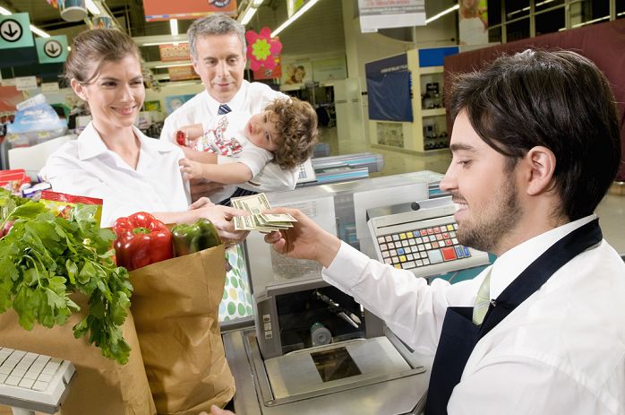Customers at checkout counter in a supermarket