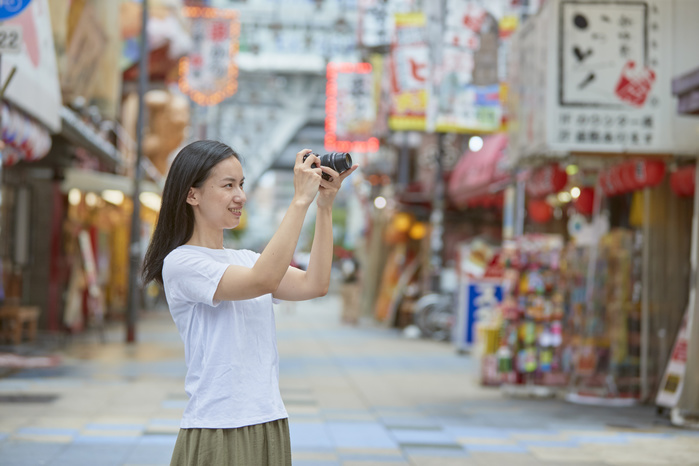 Japanese woman taking a photo in Shinsekai