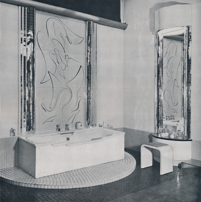  The Bath Room , 1940. Artist: Unknown.  Kenneth Cheesman for Pilkington Bros. Ltd   The Bath Room , 1940. Decorated almost entirely in  Vitrolite  and  Vitroflex  or some other form of glass   ivory and white with skirting of wedgwood blue, pilasters flanking mirror and central panel are in  Champagne . Central panel done in a combination of painted line and sandblast. Floor laid with dull grey silvered clear pressed glass tiles, semi circular raised floor done with similar tiles in concentric rings. Dressing table has an ivory opaque  Vitroflex  base and head, and the bentwood stool is faced with the same material. From Decorative Art 1940   The Studio Year Book, edited by C. G. Holme.  The Studio Ltd., London, 1940 