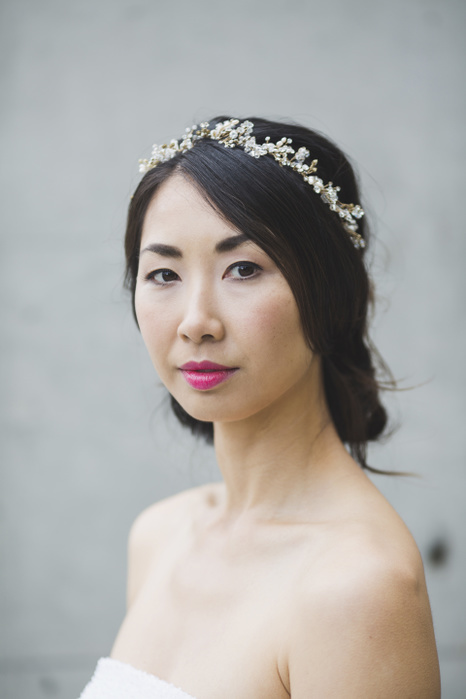 female Portrait of woman wearing tiara while standing against white wall
