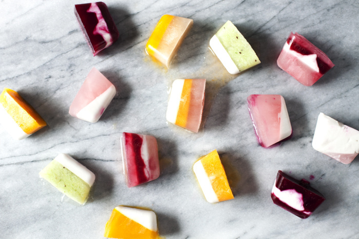 Overhead view of flavored ice cubes on marble counter