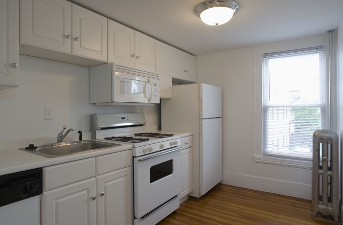 Interior Kitchen White stove and kitchen in empty apartment