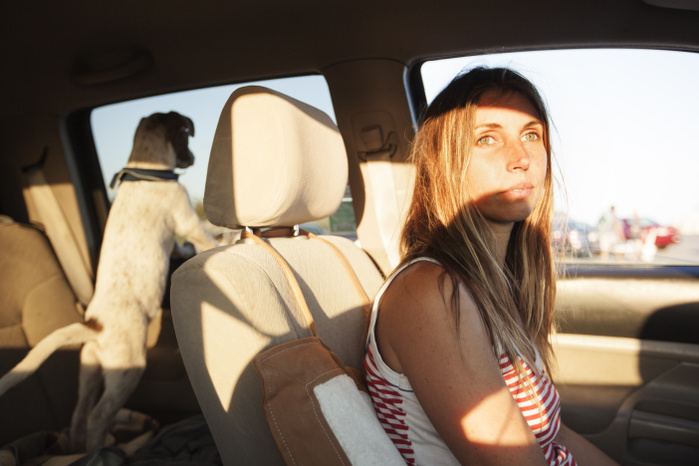 female Thoughtful woman looking away while sitting in car
