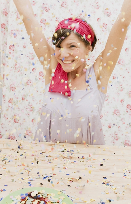 A young woman throwing confetti