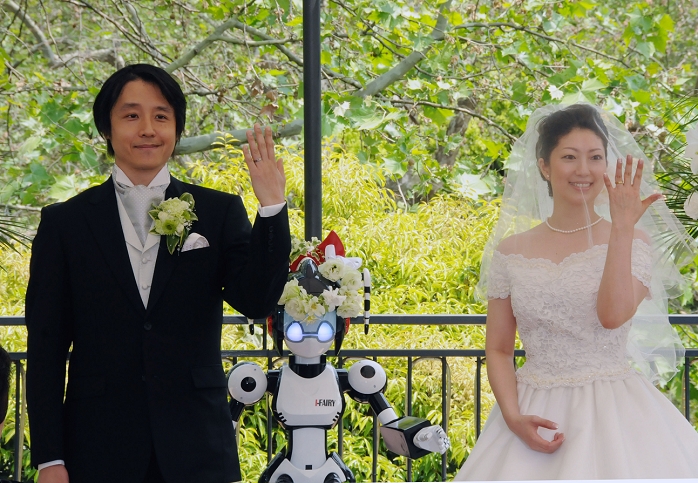 Robot witnesses a wedding Witness Representative I Fairy  May 16, 2010, Tokyo, Japan   I Fairy, a 1.5 meter tall robot with flashing eyes and plastic pigtails, conducts a wedding ceremony for Tomohiro Shibata, 42, a professor of robotics at the Nara Institute of Science and Technology in central Japan, and his bride Satoko Inouye, 35, at Tokyo s Hibiya Park on Sunday, May 16, 2010. Sunday s wedding was the first time a marriage was led by a robot, according to manufacturer Kokoro Co., where the bride works. I Fairy has 18 degrees of motion in its arms, and mainly repeats pre programmed movements and sounds.  Photo by Kaku Kurita AFLO   3618   mis   