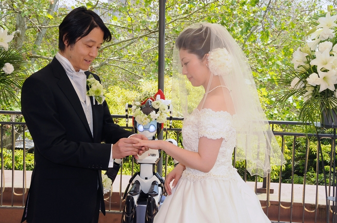 Robot witnesses a wedding Witness Representative I Fairy  May 16, 2010, Tokyo, Japan   I Fairy, a 1.5 meter tall robot with flashing eyes and plastic pigtails, conducts a wedding ceremony for Tomohiro Shibata, 42, a professor of robotics at the Nara Institute of Science and Technology in central Japan, and his bride Satoko Inouye, 35, at Tokyo s Hibiya Park on Sunday, May 16, 2010. Sunday s wedding was the first time a marriage was led by a robot, according to manufacturer Kokoro Co., where the bride works. I Fairy has 18 degrees of motion in its arms, and mainly repeats pre programmed movements and sounds.  Photo by Kaku Kurita AFLO   3618   mis   