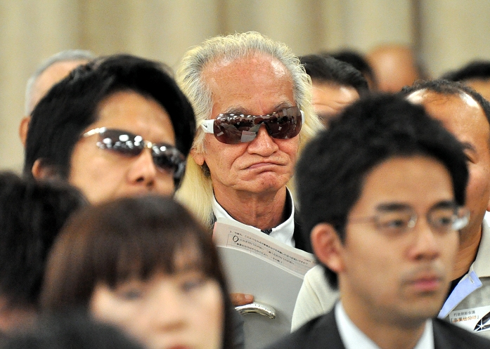 Second half of the second round of business sorting Mr. Yuya Uchida also attended the meeting May 25, 2010, Tokyo, Japan   Japanese rock musisian Yuya Uchida, gold hair and dark glasses, observes the morning session of the Government Revitalization Unit s budget screening in Tokyo on Tuesday, May 25, 2010. The 71 year old rock  n  roller gave his encouragement to the unit members who wrapped up the second half of the screening after scrutinizing 24 projects undertaken by 22 public utility corporations in four days.  Photo by Natsuki Sakai AFLO   mis 