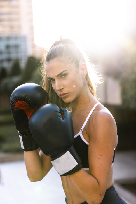 Portrait of sportive young woman boxing in the city Portrait of sportive young woman boxing in the city