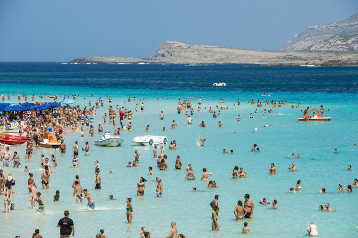 Italy Tourists enjoying the turquoise waters of famous Pelosa Beach  Stintino, Sardinia, Italy, Photo by Dosfotos